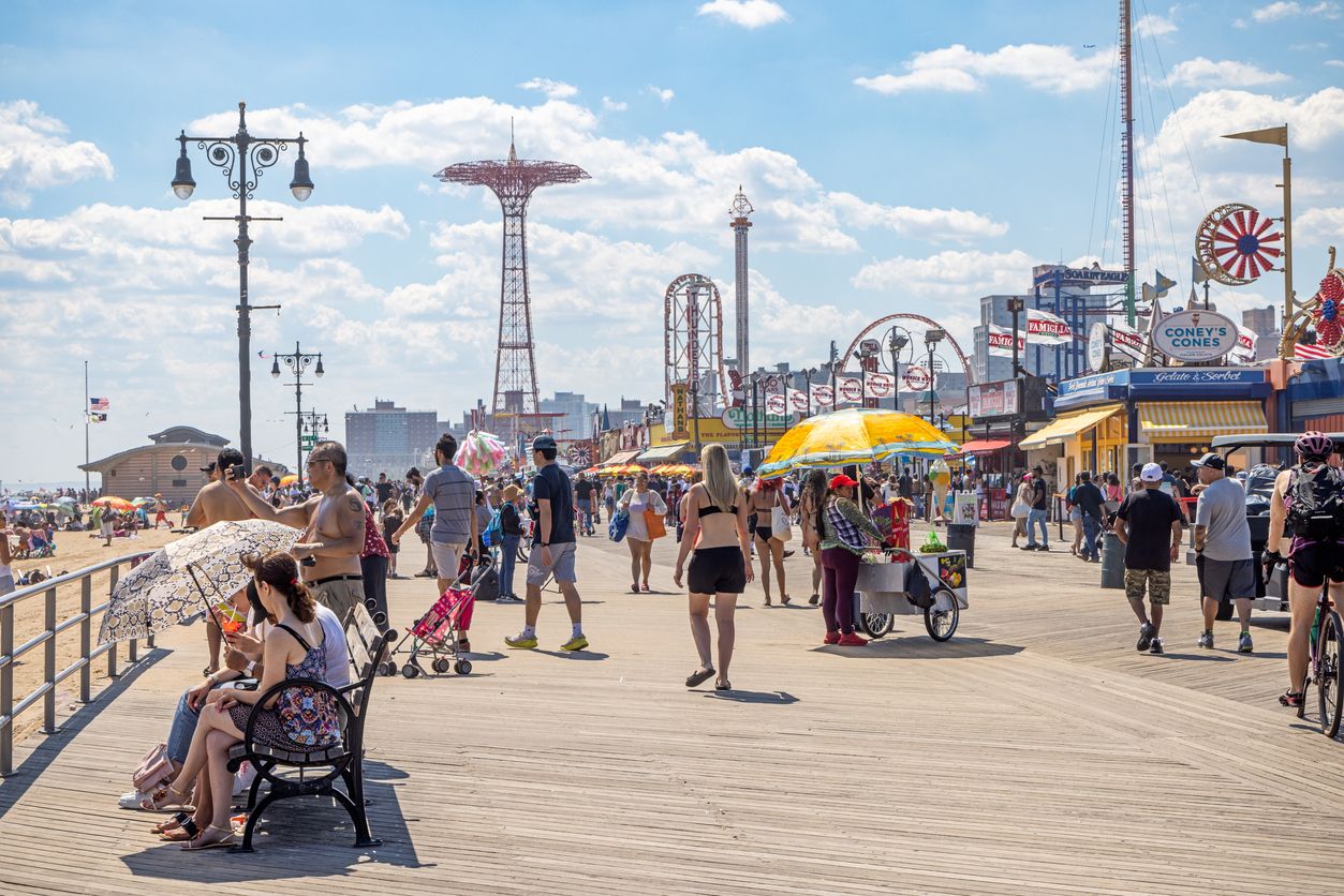 View down the Coney Island boardwalk on a busy summer day.