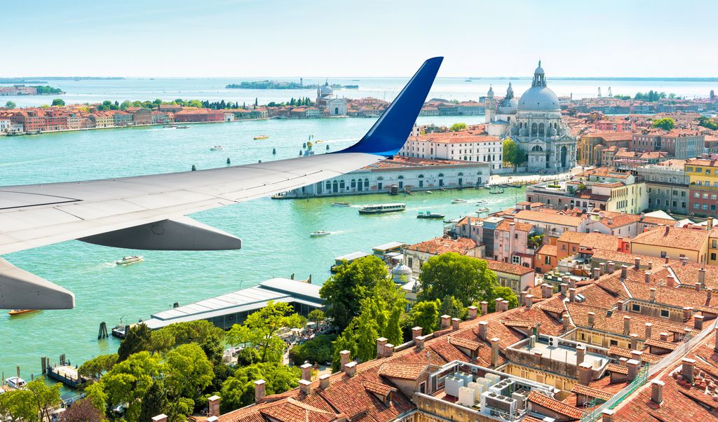 Plane flies above Venice, Italy