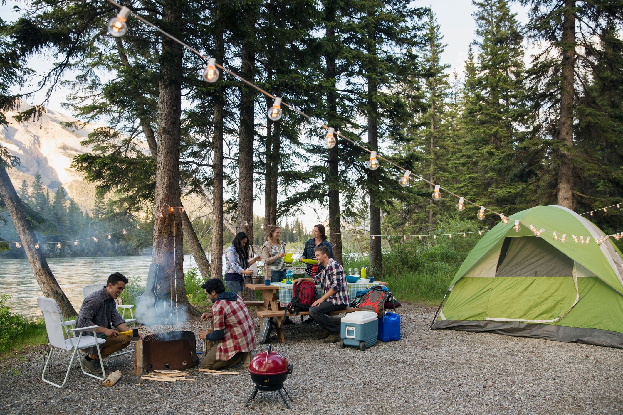 Friends hanging out at lakeside campsite