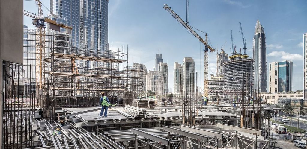 Laborers working on modern construction site works in Dubai.