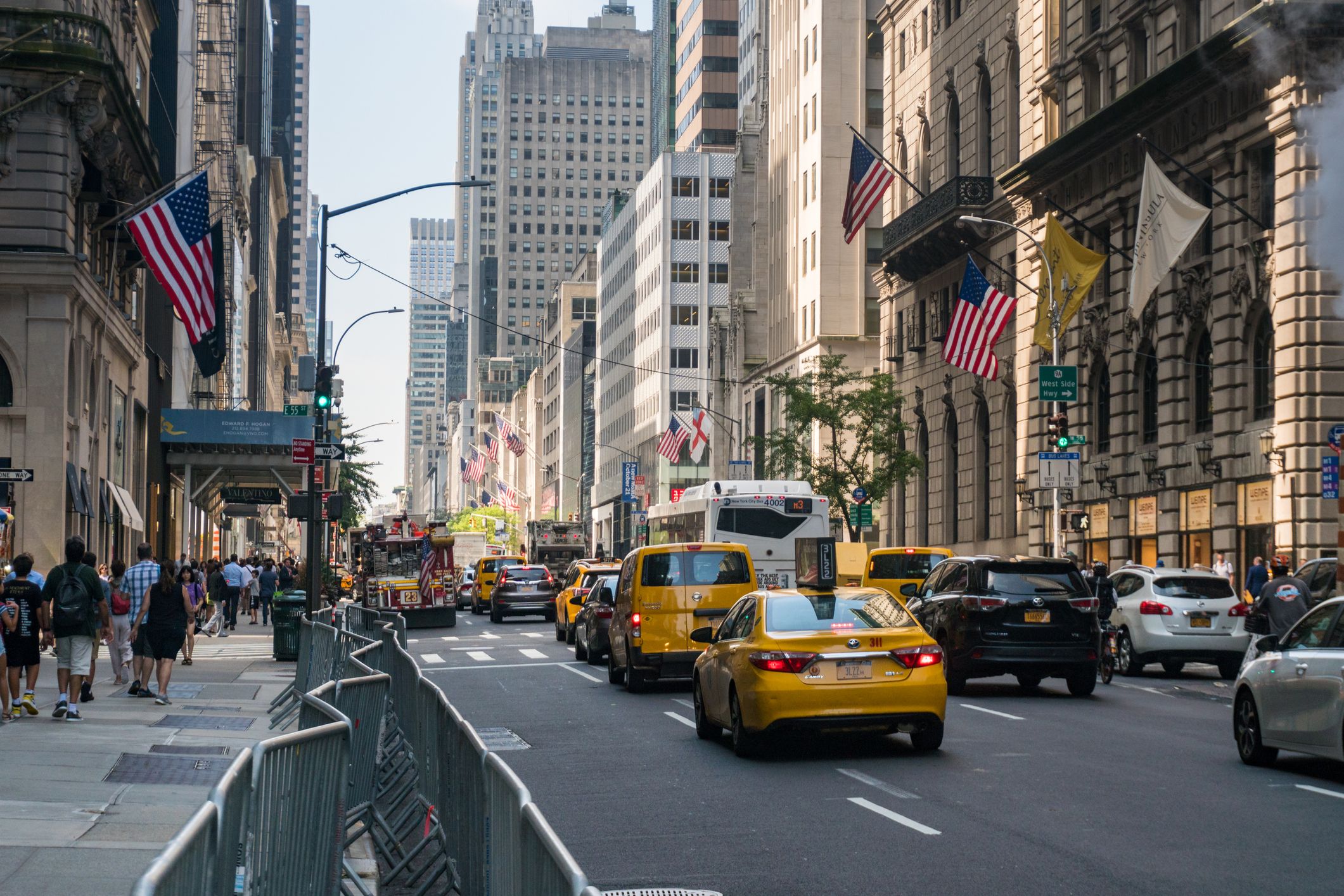 Taxis and pedestrians moving along Fifth Avenue, NYC
