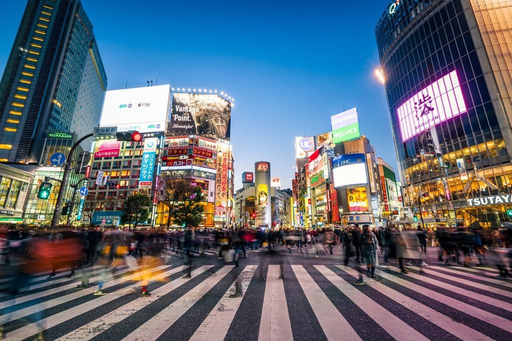 Pedestrians crossing the street at Shibuya crossing with motion blur