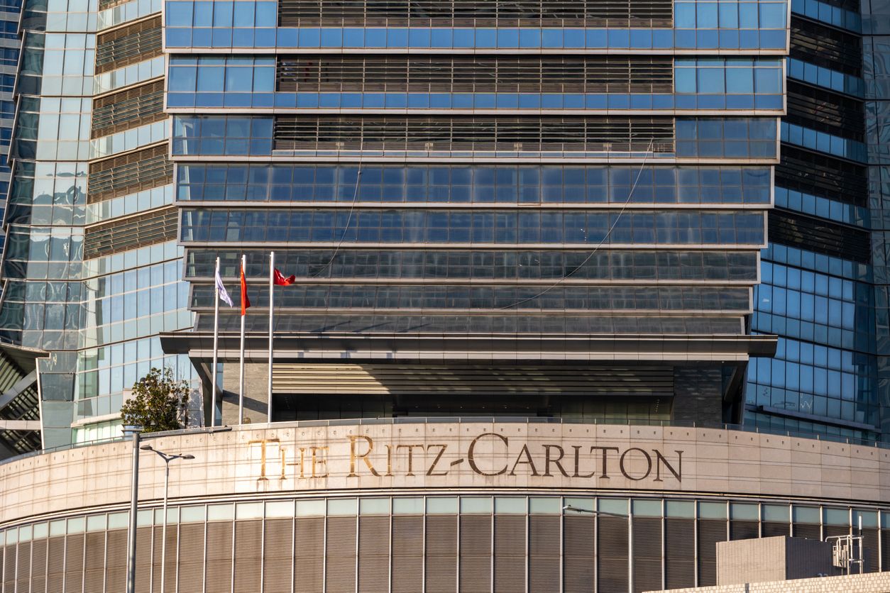 Ritz-Carlton Hong Kong with brand sign and flags.