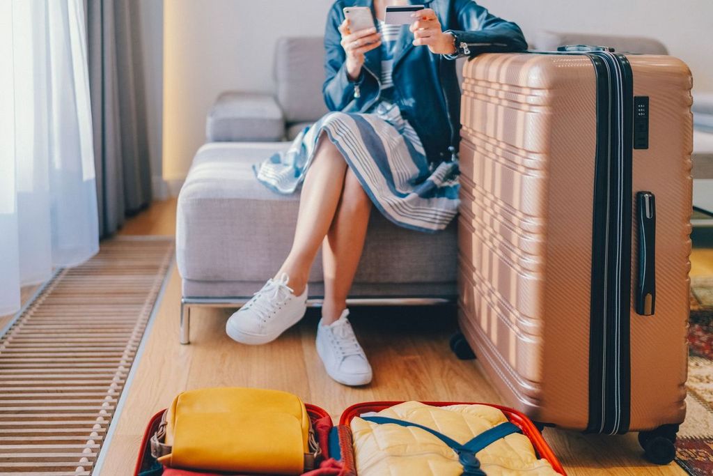 Tourist in hotel room booking online hotel reservations