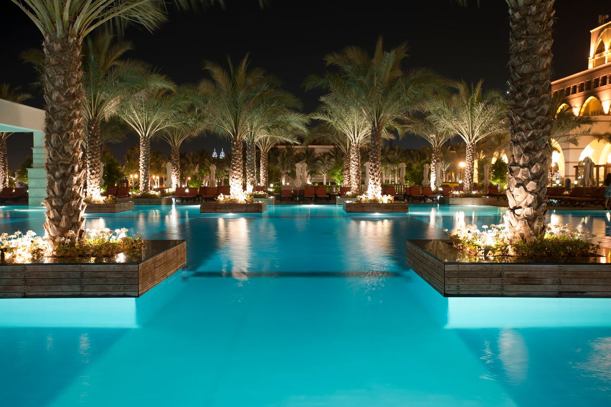 Tourist resort pool at night in Dubai.