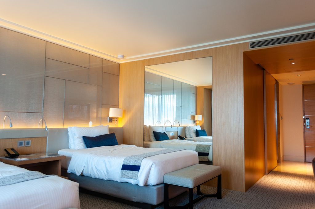 Interior of a comfortable hotel room with white bedding