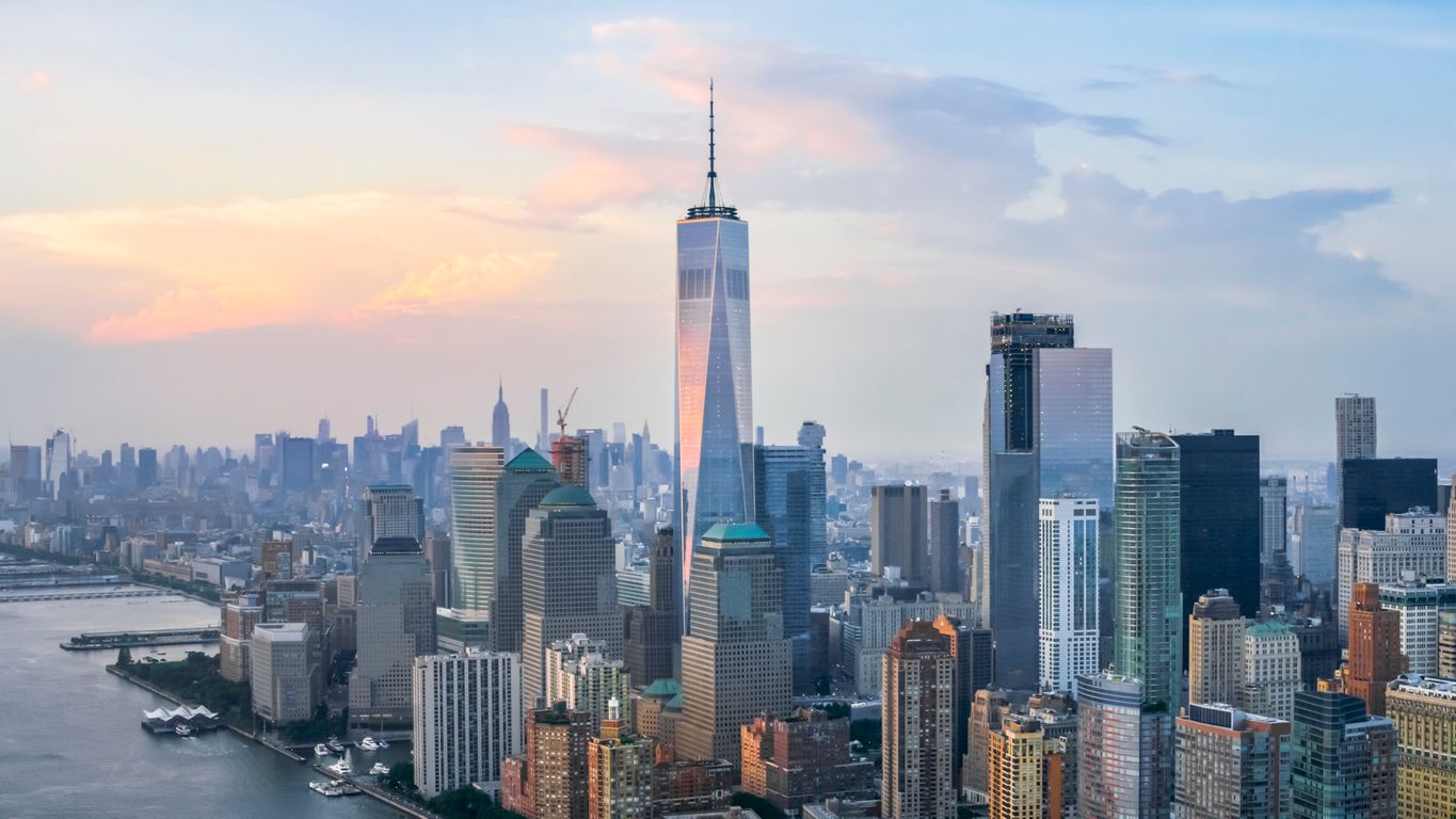 Lower Manhattan with Freedom Tower reflecting the clouds