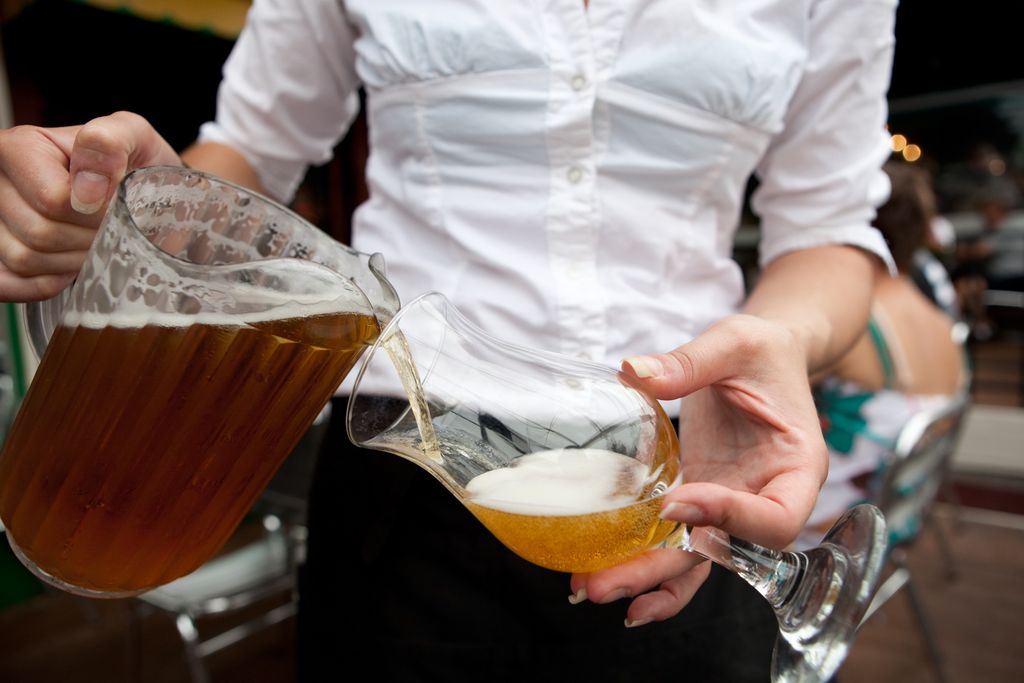 Waitress pouring a beer