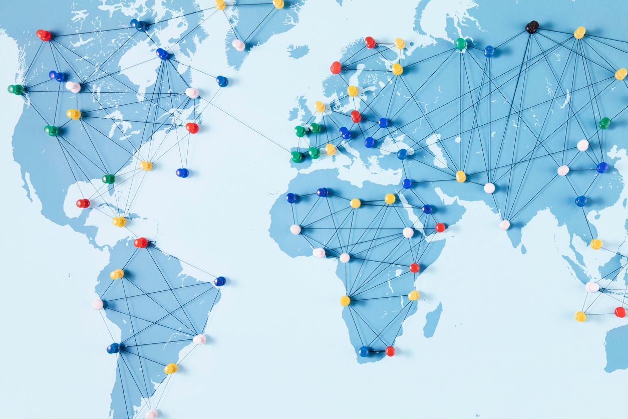Connection concept with push pins on a world map