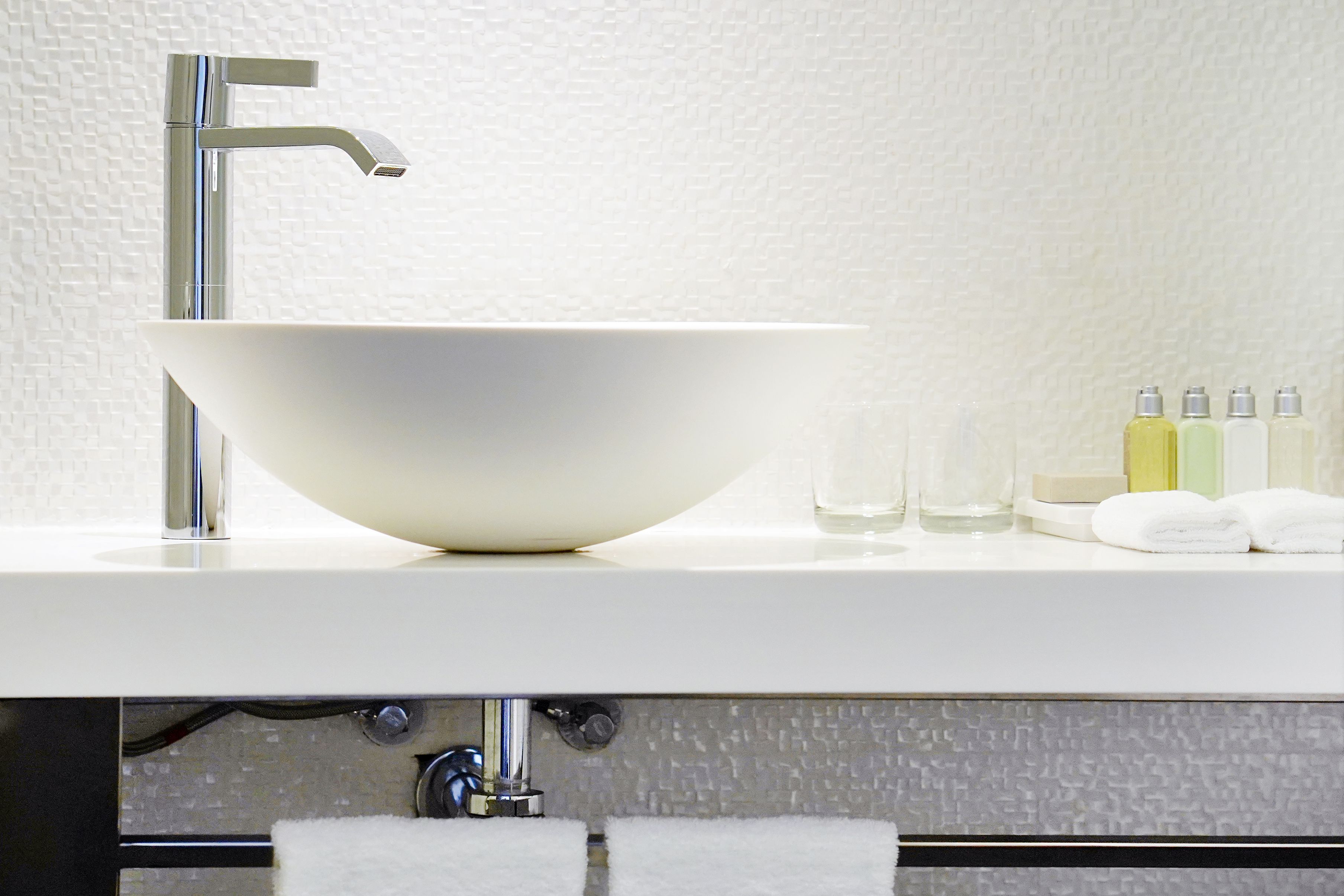 Modern white hotel bathroom sink with faucet