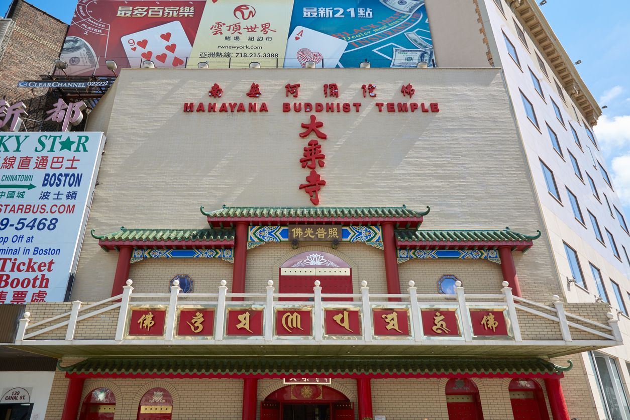 Mahayana Buddhist Temple facade with advertising billboards in New York
