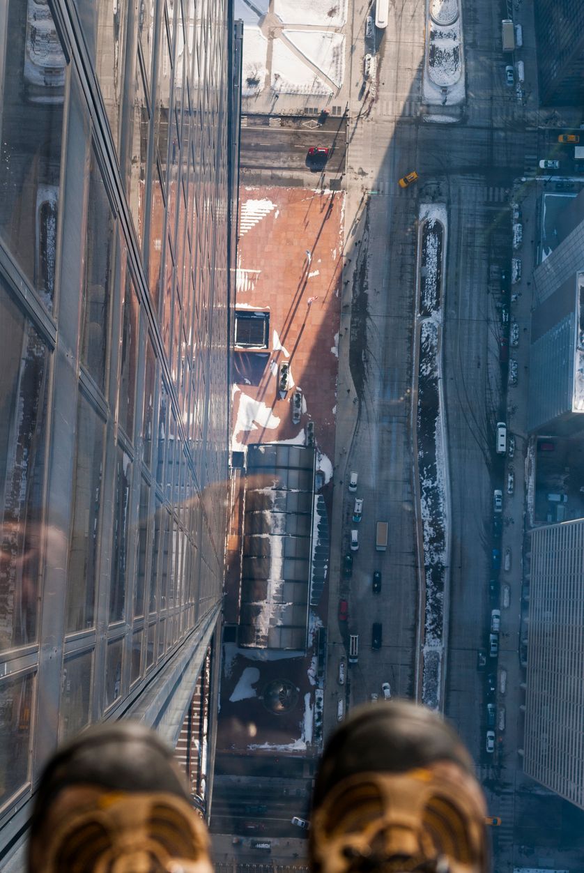 Feet on the glass balcony at the Skydeck of the Willis Tower Chicago, Illinois, USA