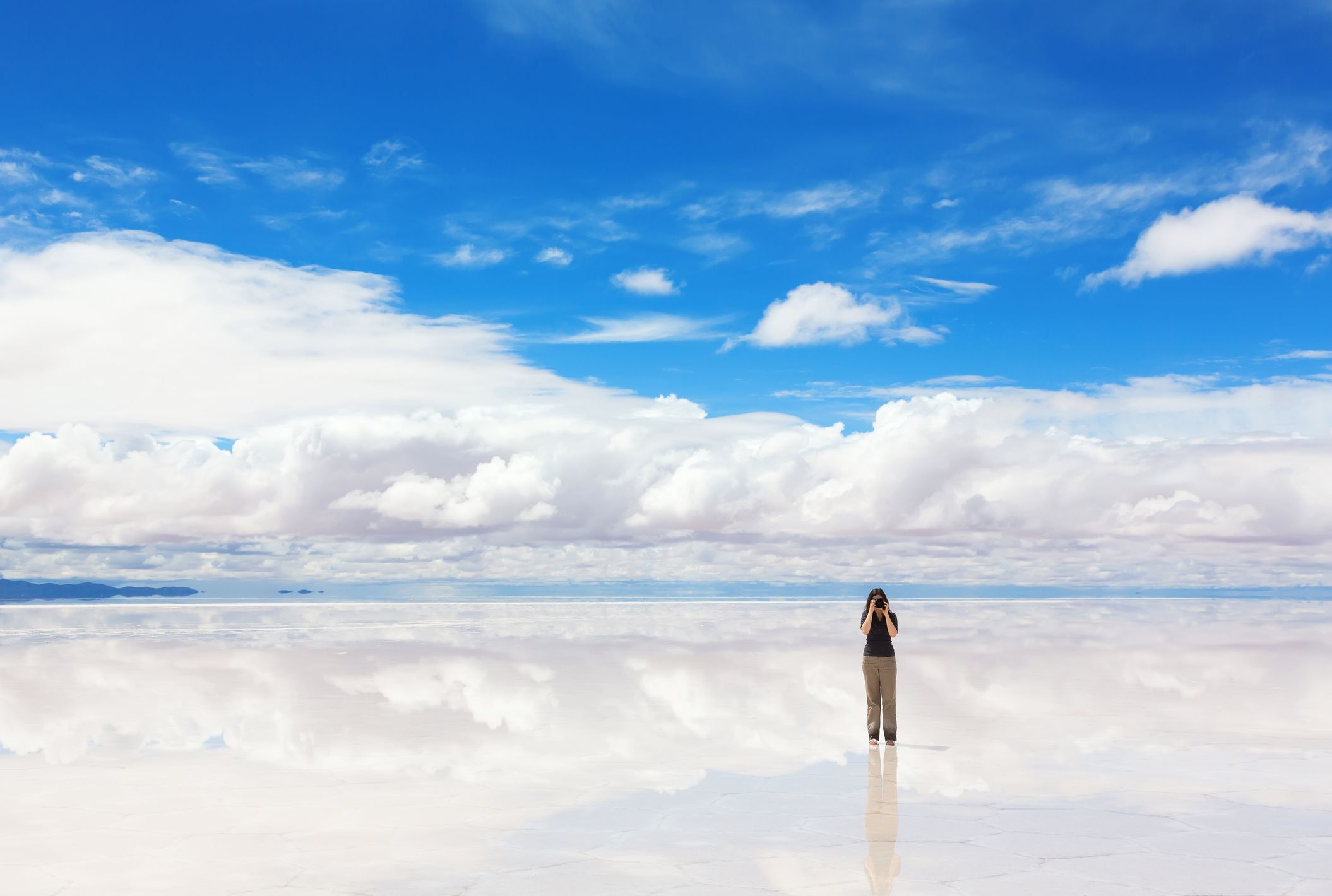 Girl taking pictures of Salar de Uyuni, Bolivia