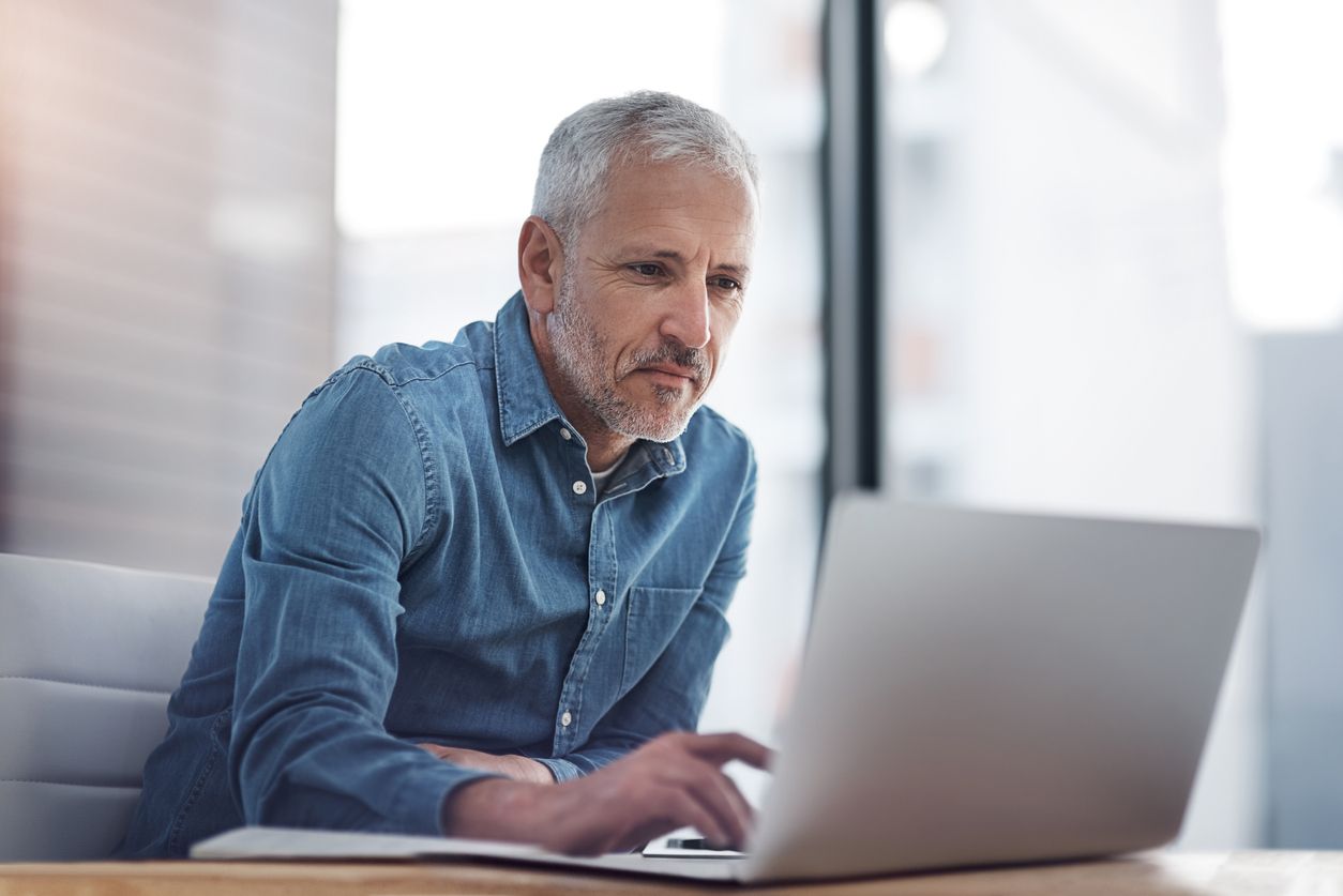 mature businessman working on a laptop