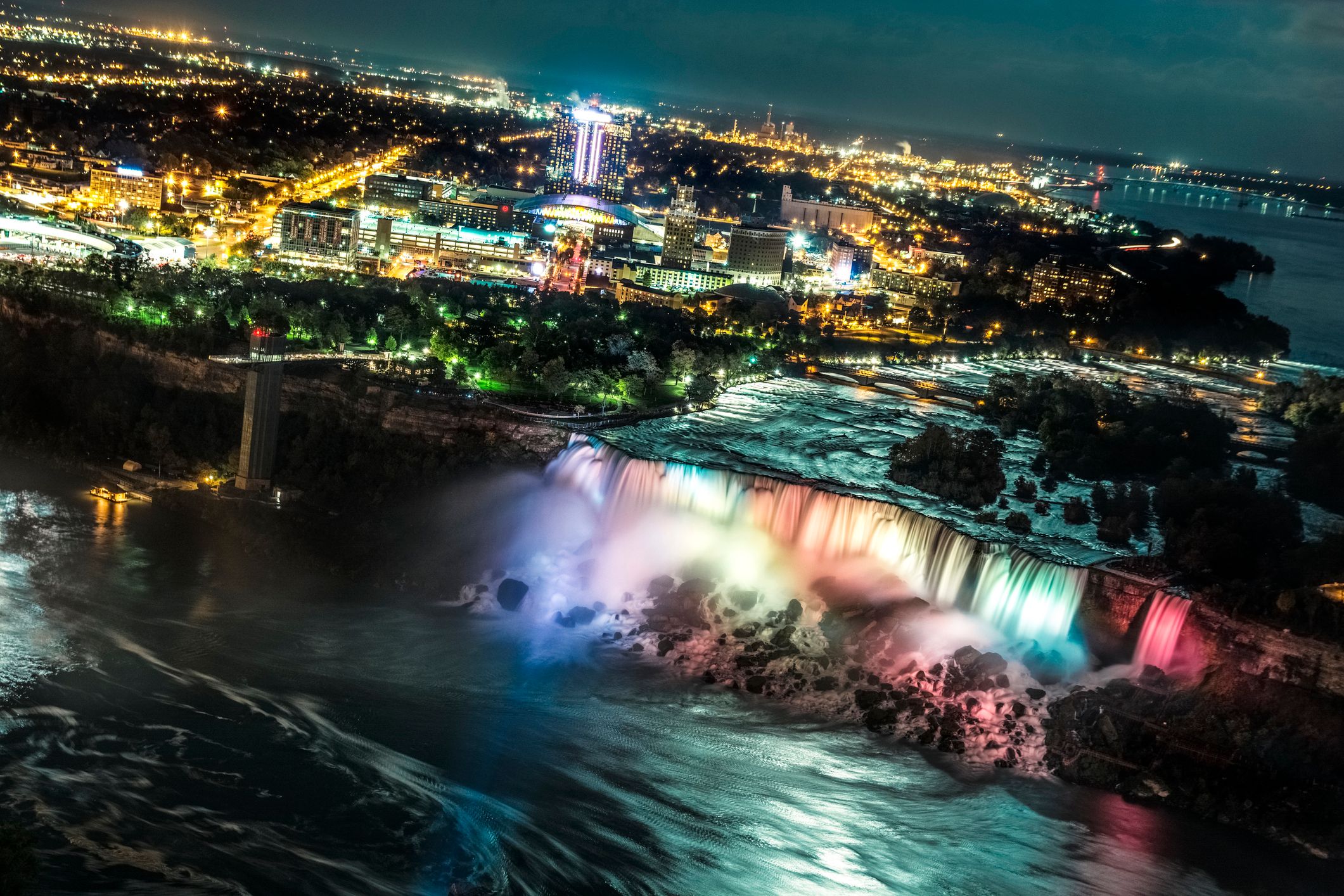 Niagara Falls with American Falls skyline at night, aerial view from Skylon Tower in Niagara Falls, Ontario