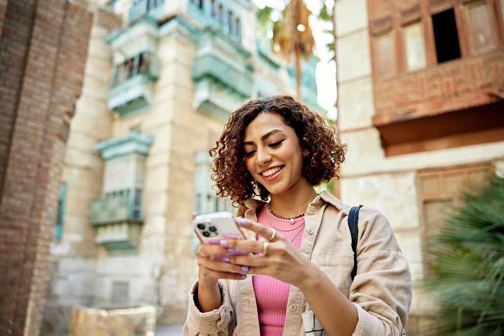 Woman looking at travel insurance options on her phone