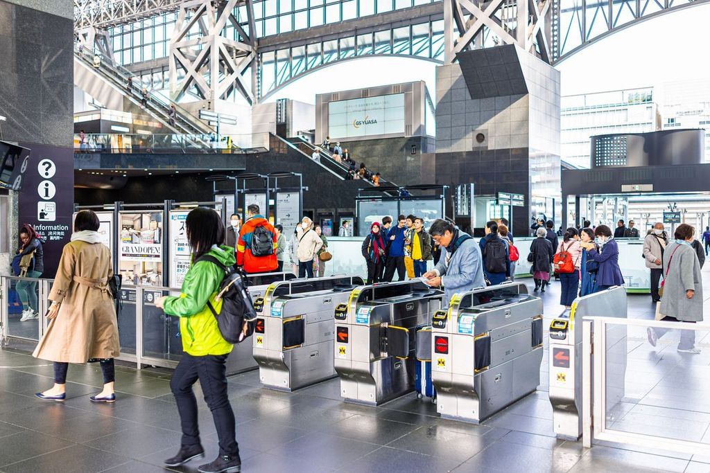 Kyoto Station with busy people entering using pass tickets with modern architecture