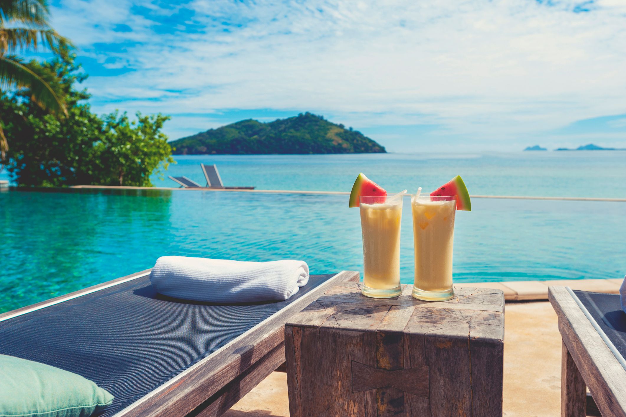 Cocktails by the pool with beach in the background